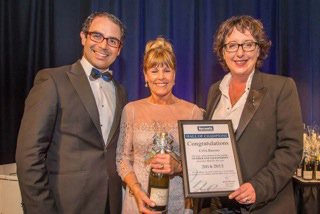 Celia Barnao collecting real estate award